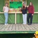 three young ladies setting up the stage for the entertainment