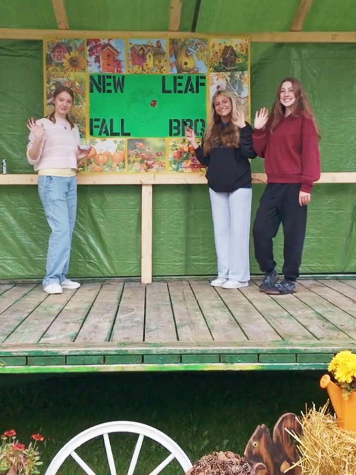 three young ladies setting up the stage for the entertainment